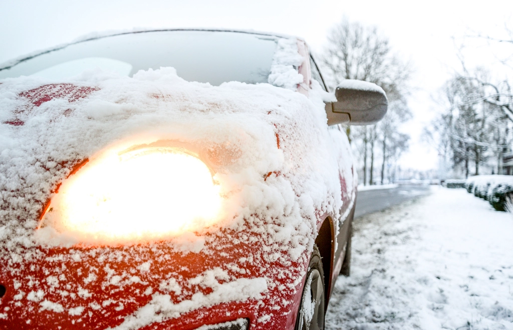 Car headlights covering snow photo